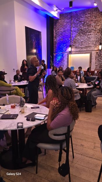 Coach Lori A. Harris leading the welcome address at The Gathering Spot’s 300 Strong event in Los Angeles, surrounded by Black women leaders.